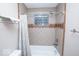 Bathroom showcasing a bathtub with decorative shower curtain and tiled walls at 4023 Cedar Hills South Dr, Greenwood, IN 46143