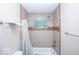 Bathroom showing shower and tub with tiled walls and glass block window at 4023 Cedar Hills South Dr, Greenwood, IN 46143