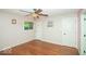 This airy bedroom features hardwood floors and a neutral paint palette at 4023 Cedar Hills South Dr, Greenwood, IN 46143