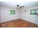 The bedroom has hardwood floors, two windows, and a ceiling fan at 4023 Cedar Hills South Dr, Greenwood, IN 46143