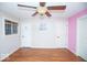 Bedroom with hardwood floors, ceiling fan and three doors at 4023 Cedar Hills South Dr, Greenwood, IN 46143