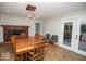 Cozy dining area with a rustic fireplace, classic table set, and access to the back patio at 4023 Cedar Hills South Dr, Greenwood, IN 46143