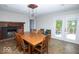 Spacious dining room featuring a wood-burning fireplace and French doors leading to an outdoor deck at 4023 Cedar Hills South Dr, Greenwood, IN 46143