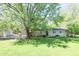 Charming home with a well-manicured lawn and a detached garage, set amidst mature trees for privacy at 4023 Cedar Hills South Dr, Greenwood, IN 46143