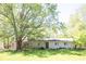 Inviting single-story home with a mature shade tree and well-maintained lawn, perfect for outdoor enjoyment at 4023 Cedar Hills South Dr, Greenwood, IN 46143