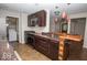 The open kitchen features stainless appliances, granite countertops and dark wood cabinetry at 4023 Cedar Hills South Dr, Greenwood, IN 46143