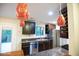 Modern kitchen with stainless steel appliances, dark wood cabinets, and adjacent dining area at 4023 Cedar Hills South Dr, Greenwood, IN 46143