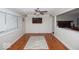 Bright living room featuring hardwood floors, a ceiling fan, and large windows for natural light at 4023 Cedar Hills South Dr, Greenwood, IN 46143