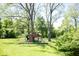 A wooden playground is nestled in the lush backyard, offering an outdoor play area at 4023 Cedar Hills South Dr, Greenwood, IN 46143