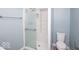 Tiled shower with a glass door and built in seat, adjacent to the toilet at 4023 Cedar Hills South Dr, Greenwood, IN 46143