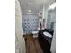 Cozy bathroom featuring a dark vanity with sink, decorative shower curtain, and essential fixtures at 4115 Tansel Rd, Indianapolis, IN 46234