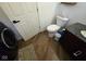 Laundry area features a toilet and sink combo and an in-unit washer and dryer at 4115 Tansel Rd, Indianapolis, IN 46234