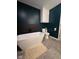 Elegant bathroom featuring a freestanding bathtub, built-in wall storage, and dark marble accents at 4115 Tansel Rd, Indianapolis, IN 46234