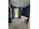 A pristine bathroom features a sleek, freestanding tub and walk-out access to the outdoors at 4115 Tansel Rd, Indianapolis, IN 46234