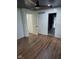 Empty room with hardwood flooring and multiple door ways leading to other rooms at 4115 Tansel Rd, Indianapolis, IN 46234