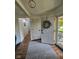 Inviting foyer featuring wood-look flooring, a decorative wreath, and a view into the house at 4115 Tansel Rd, Indianapolis, IN 46234