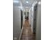 Long hallway with wood-look floors, leading to other rooms, adorned with mirrors and art at 4115 Tansel Rd, Indianapolis, IN 46234