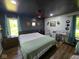 This main bedroom features a modern ceiling fan, gray walls, and bright windows that contribute to the room's inviting ambiance at 4115 Tansel Rd, Indianapolis, IN 46234