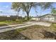 Backyard featuring a concrete slab with a walkway, leading to a detached garage at 418 Harlan St, Indianapolis, IN 46201