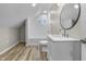 A newly remodeled bathroom features wood flooring and subway tile in a cozy space at 418 Harlan St, Indianapolis, IN 46201