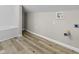 Spacious bathroom with tiled shower-tub combo and washer and dryer hookups at 418 Harlan St, Indianapolis, IN 46201
