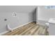 A bright bathroom featuring wood-look flooring and a white subway tile backsplash at 418 Harlan St, Indianapolis, IN 46201