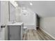 Bathroom featuring updated vanity, plank flooring, shower-tub with modern fixtures, and a bright interior at 418 Harlan St, Indianapolis, IN 46201