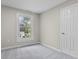 Cozy bedroom with a large window offering plenty of natural light and neutral carpet at 418 Harlan St, Indianapolis, IN 46201