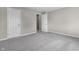 A bright bedroom with gray carpet, neutral walls, and white doors at 418 Harlan St, Indianapolis, IN 46201