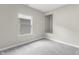 A bright bedroom with gray carpet and a window providing natural light at 418 Harlan St, Indianapolis, IN 46201