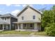 Charming two-story home with a covered front porch, ideal for relaxing and enjoying the neighborhood at 418 Harlan St, Indianapolis, IN 46201