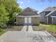 An exterior view of a house with two doors and a concrete walkway at 418 Harlan St, Indianapolis, IN 46201