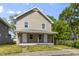 Charming two-story home with a covered front porch, featuring two entry doors and ample sunlight at 418 Harlan St, Indianapolis, IN 46201