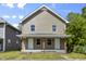 Charming two-story home with a covered front porch, perfect for enjoying the outdoors at 418 Harlan St, Indianapolis, IN 46201