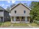 Two-story home featuring a covered front porch with sturdy wood pillars and a neatly landscaped yard at 418 Harlan St, Indianapolis, IN 46201