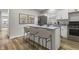 Inviting kitchen boasts granite countertops, stainless steel appliances, and an island with bar stool seating at 418 Harlan St, Indianapolis, IN 46201