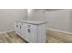 Kitchen island features granite countertops and white cabinets at 418 Harlan St, Indianapolis, IN 46201