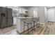Charming kitchen features stainless steel appliances, granite countertops, and an eat-in island with barstool seating at 418 Harlan St, Indianapolis, IN 46201