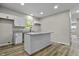 Kitchen with granite countertops, white cabinets, and modern lighting at 418 Harlan St, Indianapolis, IN 46201