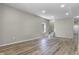 Bright, open-concept living area with new wood flooring, recessed lighting, and a staircase at 418 Harlan St, Indianapolis, IN 46201