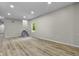 Spacious living room with hardwood floors, stairs and great natural light at 418 Harlan St, Indianapolis, IN 46201