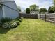 Large, fenced backyard with a healthy green lawn and simple garden at 5117 Bahia Dr, Indianapolis, IN 46237