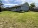 Spacious backyard featuring a lush lawn, partial fencing, and tidy landscaping at 5117 Bahia Dr, Indianapolis, IN 46237
