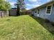 The backyard features a well-maintained lawn, a storage shed and partial fencing at 5117 Bahia Dr, Indianapolis, IN 46237