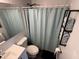 Well-lit bathroom featuring a tub/shower combo, vanity, toilet and decorative towels at 5117 Bahia Dr, Indianapolis, IN 46237