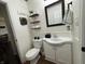 A well-maintained bathroom features a toilet, single sink vanity, and accent shelves at 5117 Bahia Dr, Indianapolis, IN 46237