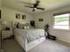 A comfy bedroom features a queen bed with storage, a ceiling fan, and plenty of natural light at 5117 Bahia Dr, Indianapolis, IN 46237