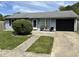 Charming single-story home featuring a well-maintained lawn and a black garage door at 5117 Bahia Dr, Indianapolis, IN 46237