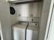 Closet laundry area with washer, dryer and above storage cabinets at 5117 Bahia Dr, Indianapolis, IN 46237