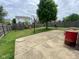 Fenced-in backyard featuring a concrete patio, basketball hoop, and a wooden shed at 5241 Waterton Lakes Dr, Indianapolis, IN 46237